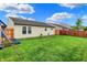 Lush green backyard with well-maintained lawn, a wooden fence, and a playset, perfect for Gathering enjoyment at 8904 Browns Valley Ln, Camby, IN 46113