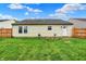 Spacious backyard with a well-kept lawn, bordered by a wooden fence, ensuring privacy and a clean aesthetic at 8904 Browns Valley Ln, Camby, IN 46113
