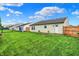 Lush backyard featuring a manicured lawn, wooden fence, and a playground set, ideal for outdoor activities at 8904 Browns Valley Ln, Camby, IN 46113