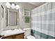 This bathroom has a large mirror, toilet, and blue-green shower curtain at 8904 Browns Valley Ln, Camby, IN 46113