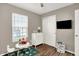 This bedroom features a window, a small table, a white dresser, and a tv at 8904 Browns Valley Ln, Camby, IN 46113