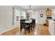 Bright dining area with a stylish chandelier, natural light, and hardwood floors at 8904 Browns Valley Ln, Camby, IN 46113