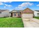 Charming brick home featuring an attached two-car garage and a well-maintained front lawn at 8904 Browns Valley Ln, Camby, IN 46113
