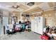 Well-lit garage featuring exposed ceiling, a refrigerator, and plenty of space for storage at 8904 Browns Valley Ln, Camby, IN 46113