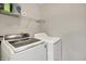This laundry room features a Samsung washing machine, a GE dryer, and shelving at 8904 Browns Valley Ln, Camby, IN 46113