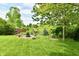 Secluded backyard firepit area surrounded by lush landscaping and mature trees at 938 Weeping Way Ln, Avon, IN 46123