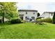 Well-maintained backyard featuring a lush lawn, patio, and mature trees at 938 Weeping Way Ln, Avon, IN 46123