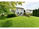 Well-maintained backyard featuring a lush lawn, patio, and mature trees at 938 Weeping Way Ln, Avon, IN 46123