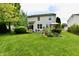 Well-maintained backyard featuring a lush lawn, patio, and mature trees at 938 Weeping Way Ln, Avon, IN 46123