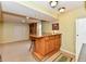 Basement area featuring a bar with seating, tile floor and carpet beyond at 938 Weeping Way Ln, Avon, IN 46123