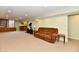 Finished basement featuring carpeting, bar area, and exercise equipment at 938 Weeping Way Ln, Avon, IN 46123