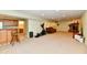 Basement area including a bar, treadmill, sofa and fireplace at 938 Weeping Way Ln, Avon, IN 46123