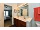 Bright bathroom features a double sink vanity and access to the main bedroom at 938 Weeping Way Ln, Avon, IN 46123