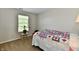 Bedroom with carpet flooring, neutral walls, and a bed with a patterned bedspread near a window at 938 Weeping Way Ln, Avon, IN 46123