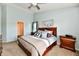 Bedroom featuring carpet flooring, light blue walls, a wooden framed bed, and matching nightstands at 938 Weeping Way Ln, Avon, IN 46123