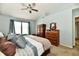 Bedroom with carpet flooring, a ceiling fan, and light blue walls with a dark wood bed frame at 938 Weeping Way Ln, Avon, IN 46123