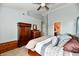 Bedroom with carpet flooring, light blue walls, a ceiling fan, and multiple wooden furniture pieces at 938 Weeping Way Ln, Avon, IN 46123