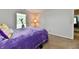 Bedroom with neutral walls, carpet flooring, a plush purple bedspread, and a plant by the window at 938 Weeping Way Ln, Avon, IN 46123