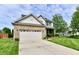 Well-maintained two-story home with brick accents, a spacious driveway and manicured lawn at 938 Weeping Way Ln, Avon, IN 46123