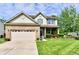 Charming two-story home with brick and siding, a well-manicured lawn and lovely flower beds at 938 Weeping Way Ln, Avon, IN 46123