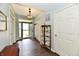 Bright foyer featuring dark wood floors, a glass cabinet, and a view of the front yard at 938 Weeping Way Ln, Avon, IN 46123