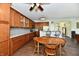 Open kitchen with wooden cabinets, granite countertops, and stainless steel appliances with eat in dining area at 938 Weeping Way Ln, Avon, IN 46123