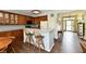 Updated kitchen features wood cabinets, granite countertops, stainless appliances and breakfast bar area at 938 Weeping Way Ln, Avon, IN 46123