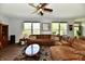 Bright living room with hardwood floors, large windows, comfortable seating, and ceiling fan at 938 Weeping Way Ln, Avon, IN 46123