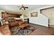 Comfortable living room with a brown sectional sofa, wood floors, and a neutral color scheme at 938 Weeping Way Ln, Avon, IN 46123
