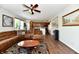 Inviting living room featuring a comfortable brown sectional sofa and adjacent kitchen at 938 Weeping Way Ln, Avon, IN 46123