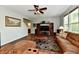 Living room featuring wood floors, a comfortable sofa, and a media center with ample storage at 938 Weeping Way Ln, Avon, IN 46123