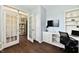 Comfortable office featuring modern desk setup with bright light, built in cabinets and hardwood flooring at 938 Weeping Way Ln, Avon, IN 46123