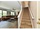 Carpeted staircase leading up from an open living area, enhancing the home's access and flow at 938 Weeping Way Ln, Avon, IN 46123