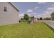 Large backyard with green lawn, swing set, tree, and privacy fence; plenty of room to play! at 951 Gondola Run, Greenfield, IN 46140