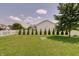 Well-maintained backyard featuring a lush lawn, a picket fence, and lush landscaping at 951 Gondola Run, Greenfield, IN 46140