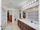 Bright bathroom featuring double sinks, tile floors, and walk-in closets on either side of the room at 951 Gondola Run, Greenfield, IN 46140
