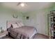 Well-lit bedroom with light green walls, carpet, and a double bed with throw pillows at 951 Gondola Run, Greenfield, IN 46140