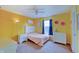 This bedroom features yellow walls, carpet, a window with natural light, and a double bed at 951 Gondola Run, Greenfield, IN 46140