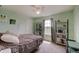 Cozy bedroom with light green walls, carpet, shelving units, window, and ceiling fan at 951 Gondola Run, Greenfield, IN 46140