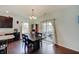 Inviting dining area with hardwood floors, chandelier, and sliding glass doors to the patio at 951 Gondola Run, Greenfield, IN 46140