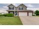 Charming two-story home with a manicured lawn, brick accents, and a spacious three-car garage at 951 Gondola Run, Greenfield, IN 46140