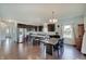 Open concept kitchen and dining area features stainless appliances and hardwood floors at 951 Gondola Run, Greenfield, IN 46140