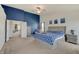 View of the main bedroom with blue accent wall, carpet, ceiling fan, and sitting area at 951 Gondola Run, Greenfield, IN 46140