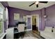 Bright office with modern furniture, purple walls, hardwood floors, and ample natural light at 951 Gondola Run, Greenfield, IN 46140