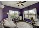 Stylish office with large windows, hardwood floors, purple walls, and bright natural light at 951 Gondola Run, Greenfield, IN 46140