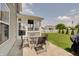 Back patio with outdoor seating area and view of the yard and fenced perimeter at 951 Gondola Run, Greenfield, IN 46140
