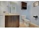 Cozy powder room with light blue walls, a dark vanity, and tile floors at 951 Gondola Run, Greenfield, IN 46140