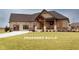 Charming one-story home featuring a covered porch with stone columns and a well-manicured lawn at Lot 2 Vanderbilt Dr, Anderson, IN 46011