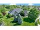Aerial view of a brick and yellow siding home with an expansive lawn and established trees at 1020 Lair Ct, Westfield, IN 46074
