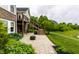 Paver patio features a staircase leading to a deck overlooking the landscaped yard at 1020 Lair Ct, Westfield, IN 46074